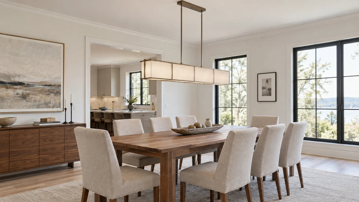 Modern linear chandelier centered above a rectangular table in a bright dining room.