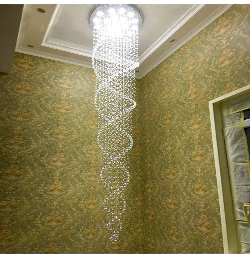 A modern spiral crystal LED ceiling chandelier with cascading tiers of clear faceted beads and a circular fixture