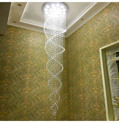 A modern spiral crystal LED ceiling chandelier with cascading tiers of clear faceted beads and a circular fixture