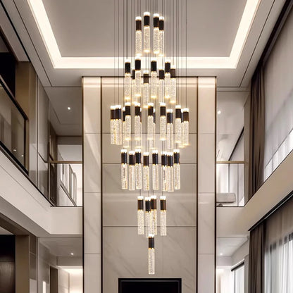 Elegant modern crystal chandelier with cascading tubes and black accents in a luxury high-ceilinged hallway