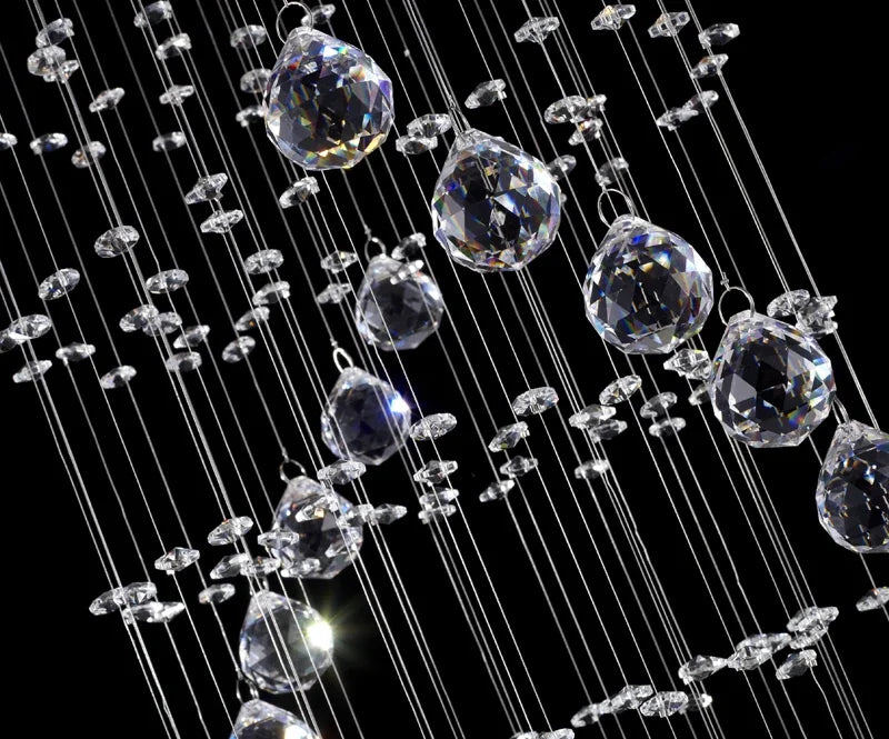 A modern spiral crystal led ceiling chandelier with clear faceted crystal droplets suspended on fine wires