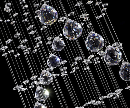 A modern spiral crystal led ceiling chandelier with clear faceted crystal droplets suspended on fine wires
