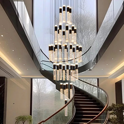 Modern crystal chandelier with cascading cylindrical glass tubes capped in black and warm led lights inside